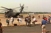 Image: U.S. citizens evacuated from Liberia exit a U.S. Air Force MH-53 Pavelow.