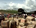 Image: Villagers from Casamacoa, Honduras, carry relief supplies away from a CH-47 Chinook.