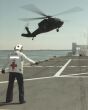 Image: A UH 60A Black Hawk helicopter flies toward the USNS Comfort AH 20.