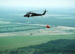 Image: An Army Blackhawk helicopter carries a 700 gallon water bucket to fight forest fires.