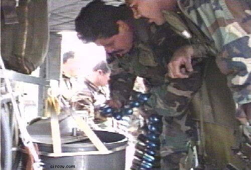 Image: Armament personnel loading the rotary drum with M385 ammo.